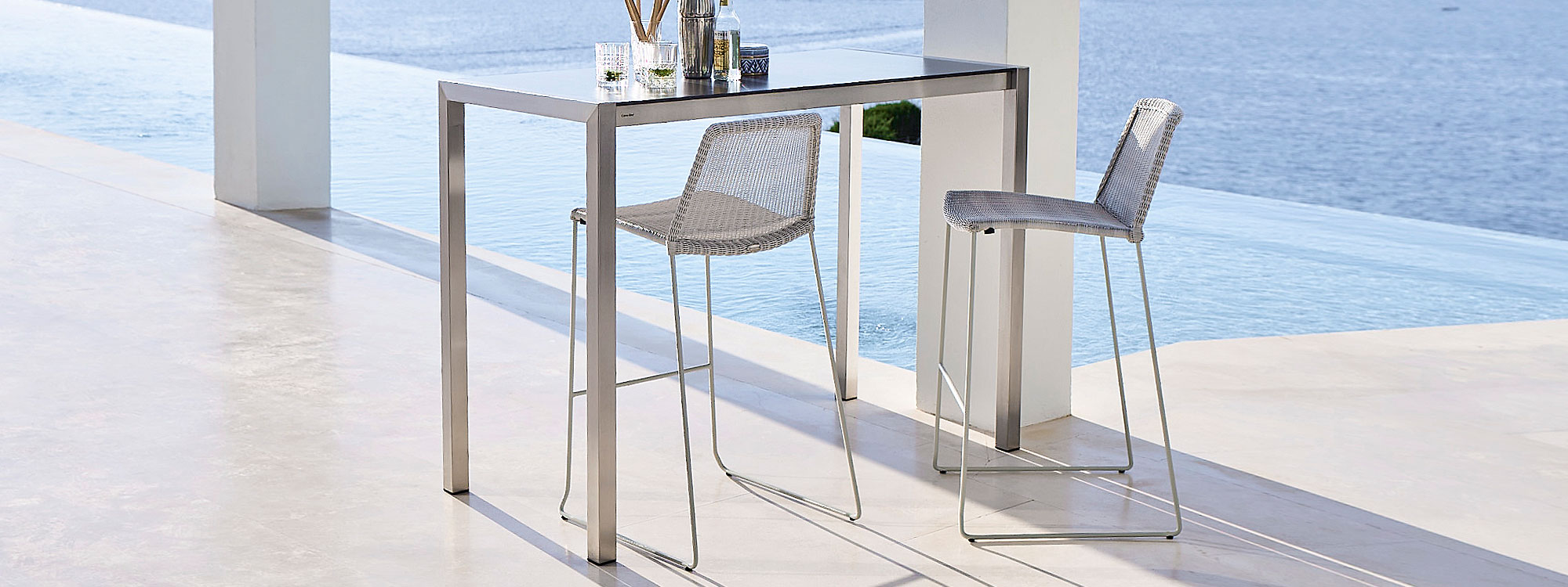 Drop bar table & Breeze modern bar stool is a contemporary outdoor bar chair in luxury quality garden furniture materials by Cane-Line modern garden furniture company