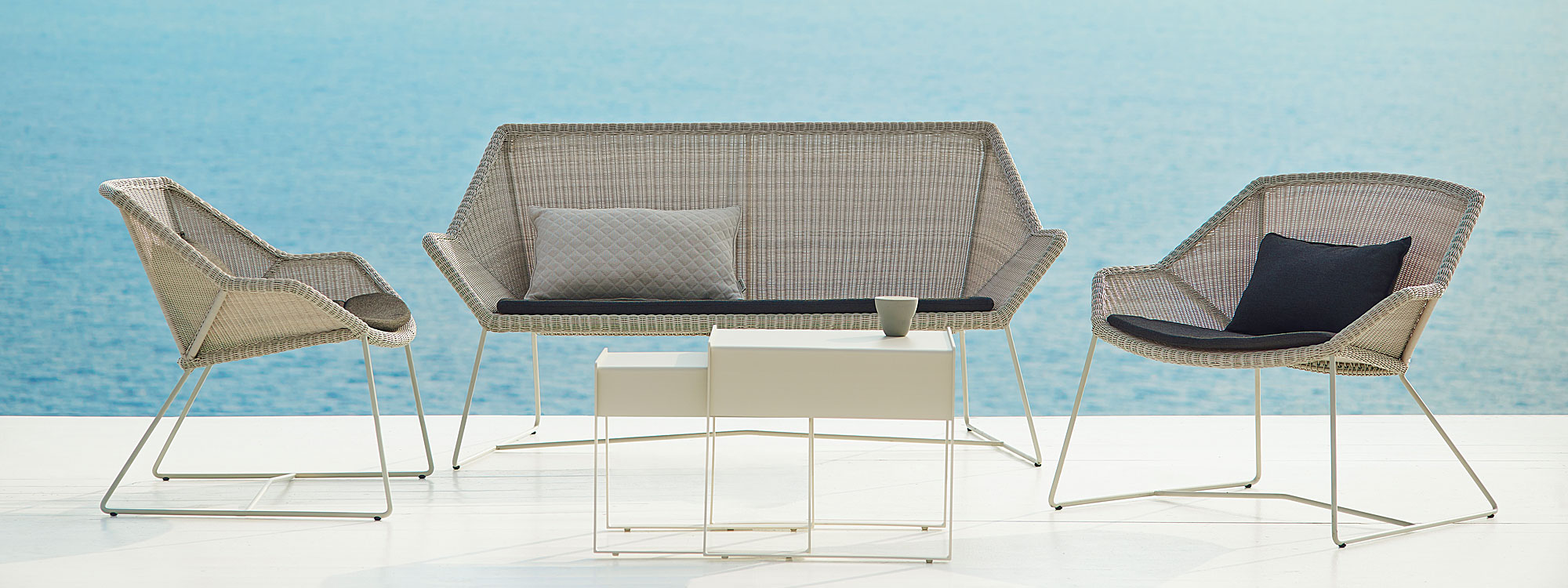 Light-grey Breeze modern outdoor lounge furniture includes a contemporary garden sofa & garden relax chairs by Cane-line all-weather furniture company.