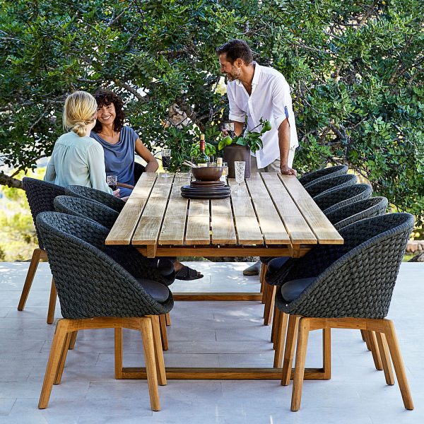 Peacock chairs & Endless teak table includes modern garden dining tables in WWF certified teak furniture materials by Caneline outdoor furniture company
