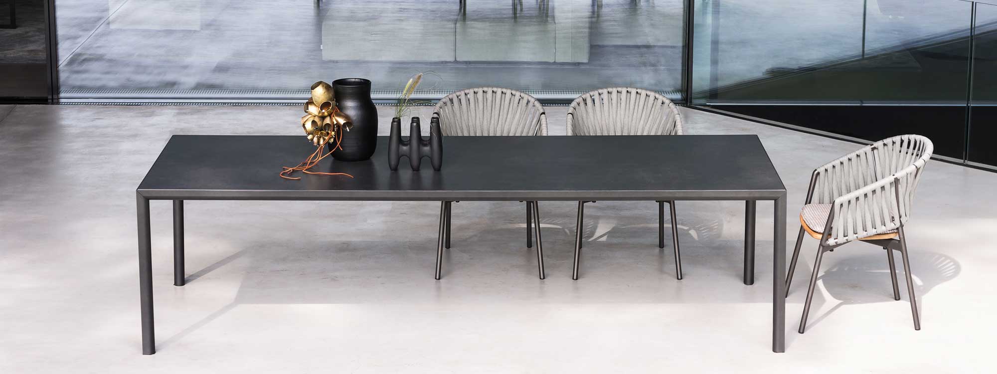 Plein Air outdoor table with Piper comfort chairs on polished concrete floor