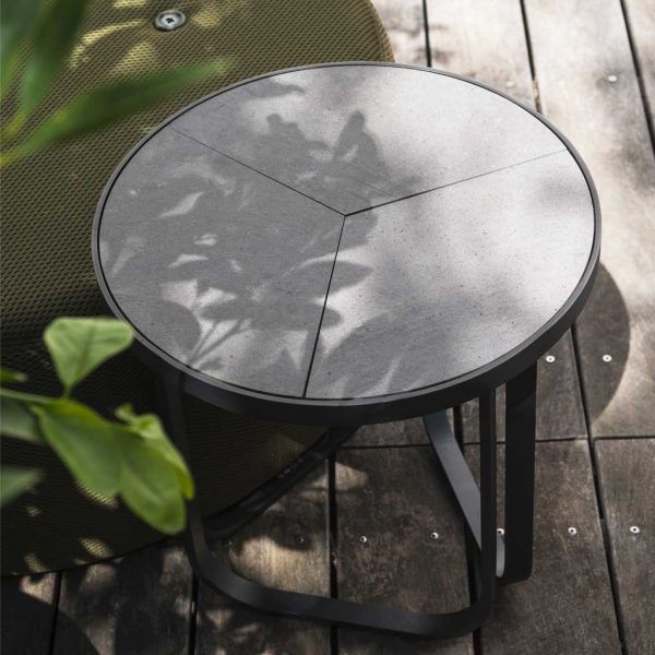 Thea outdoor side table shown on wooden decking